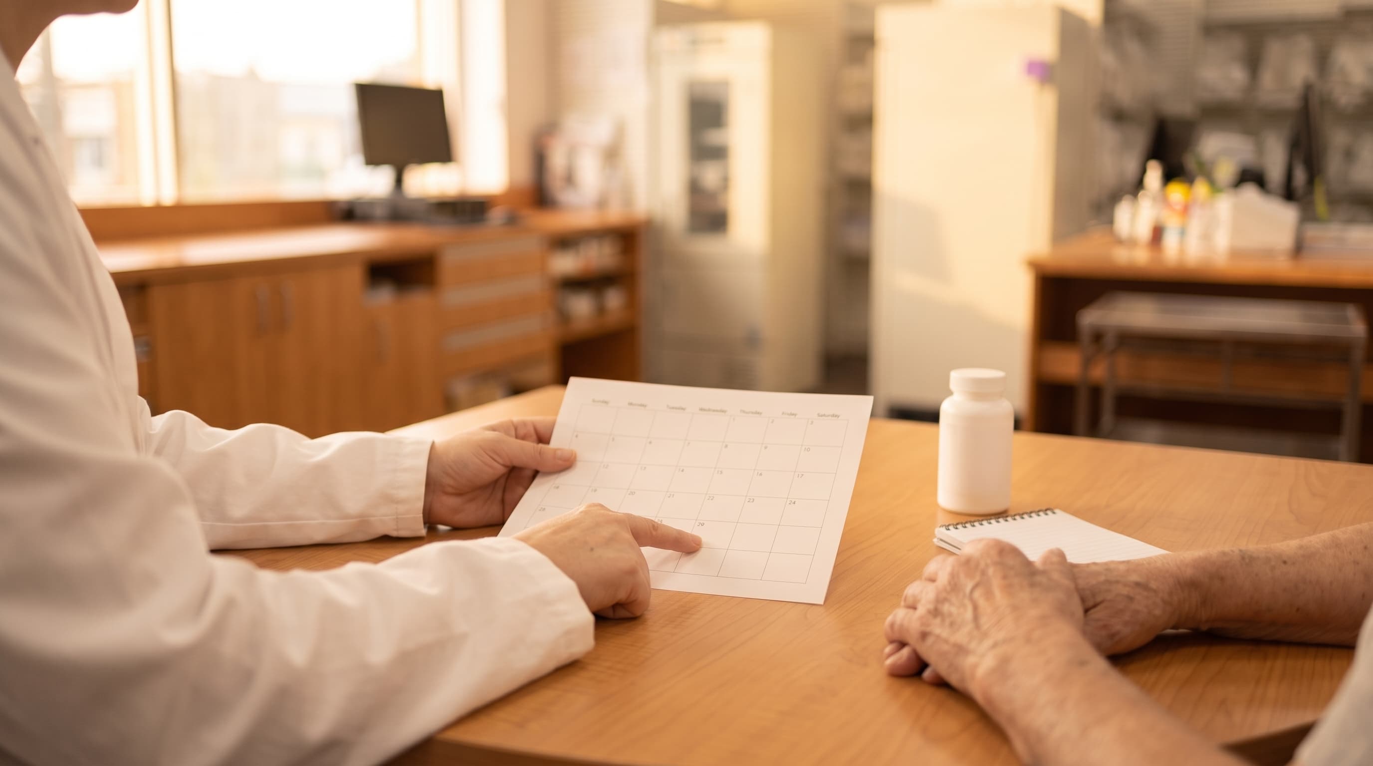 Pharmacist speaking with a patient in a private consultation room